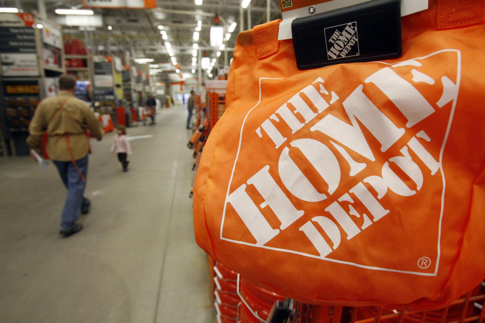 FILE -0 In this file photograph taken Feb. 23, 2010, shoppers and sales representatives walk through the aisles at the Home Depot store in Williston, Vt. Modest sales increases helped boost Home Depot Inc.'s second-quarter net income 7 percent Tuesday, Aug. 17, 2010. (AP Photo/Toby Talbot, file)