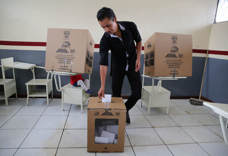 A man casts his vote in a school used as a polling station during the presidential election, in Quito, Ecuador April 2, 2017. REUTERS/Mariana Bazo