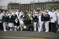 Medical workers who tend to COVID-19 patients and who received a medal from the government as recognition for their efforts pose for a photo with an Army mascot during the annual Independence Day military parade in Mexico City’s main square of the capital, the Zócalo, Wednesday, Sept. 16, 2020. Mexico celebrates the anniversary of its independence uprising of 1810. ( AP Photo/Marco Ugarte)