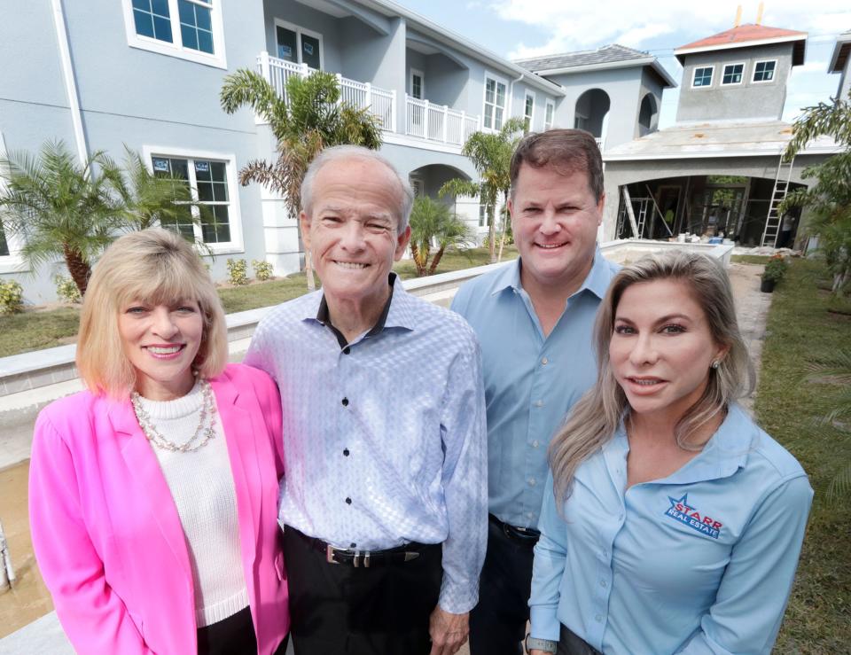 Nancy Lohman, left, her husband Lowell, son Ty and daughter-in-law Tovah stand in the central courtyard at the nearly completed Cupola at Oceanside luxury townhomes at 100 N. Halifax Drive in Ormond Beach. The Lohmans, who developed the project, expect residents to begin moving in by the end of the month.