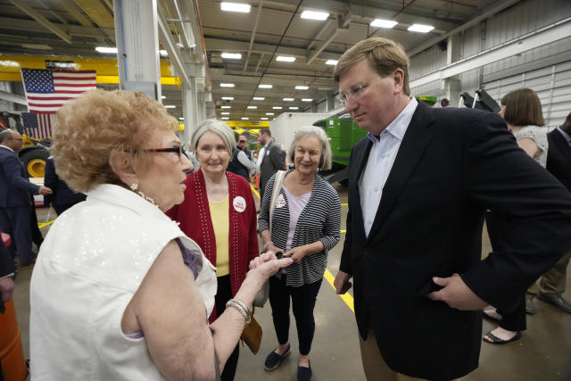 Edith Yates, left, speaks with Mississippi Republican Gov. Tate Reeves, right, about some of her election concerns following a rally at Stribling Equipment in Richland, Miss., Wednesday, May 3, 2023. Pat Bruce, center, and Judy Batson, friends of Yates, listen in on the conversation. Reeves is seeking reelection for a second term. (AP Photo/Rogelio V. Solis)