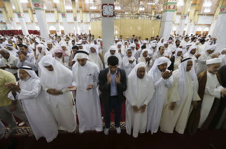 Sunni and Shi'ites conduct joint Friday prayers to show solidarity and co-existence between the two sects of Islam at Al A'ali Grand Mosque in Al A'ali south of Manama, July 3, 2015. REUTERS/Hamad I Mohammed