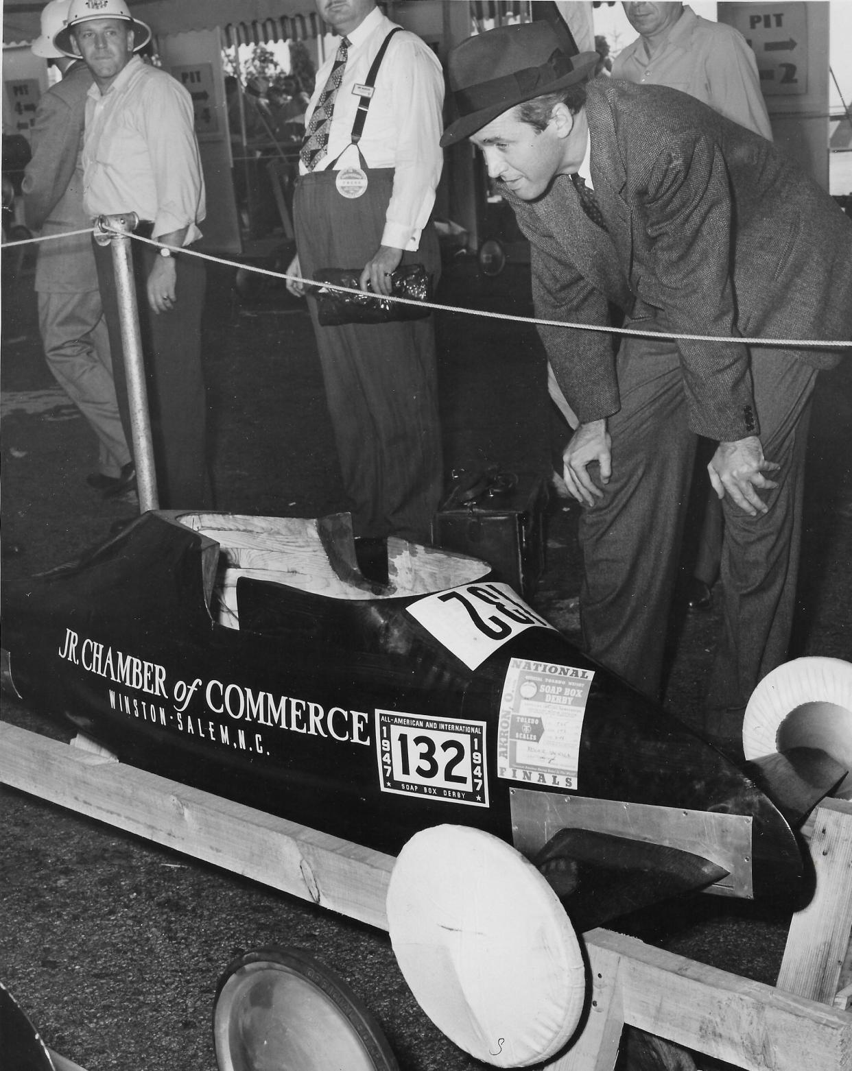 Hollywood star Jimmy Stewart inspects a race car Aug. 16, 1947, at Derby Downs before the All-American Soap Box Derby in Akron.