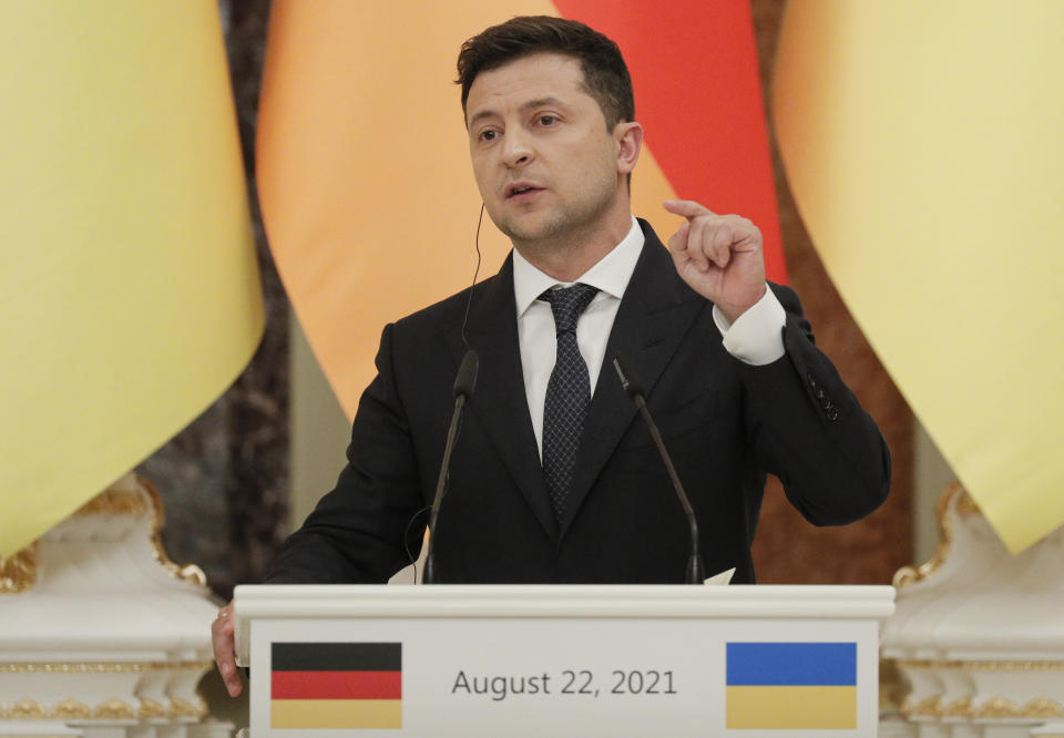 Ukrainian President Ukrainian President Volodymyr Zelenskyy attends a joint news conference with German Chancellor Angela Merkel following their talks at the Mariinsky palace in Kyiv, Ukraine, Sunday, Aug. 22, 2021. German Chancellor Angela Merkel arrived to Kyiv for a working visit to meet with top Ukrainian officials. (Sergey Dolzhenko/Pool Photo via AP)