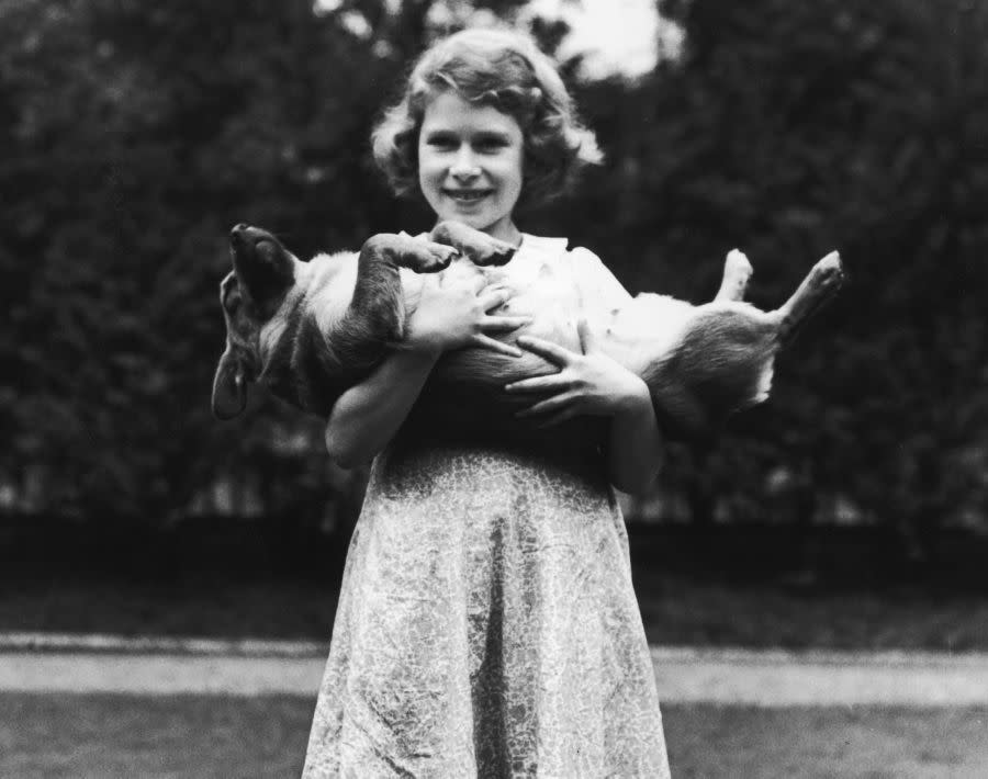Not exactly a typical child growing up, Elizabeth was third in line to the throne behind her father and her uncle, Edward VIII, Prince of Wales. As a girl, she was homeschooled with her younger sister, Margaret, and had a love for animals. Here, the 9-year-old princess plays with a corgi. During her reign, Queen Elizabeth has owned a total of 30 corgis. The first was called Susan.