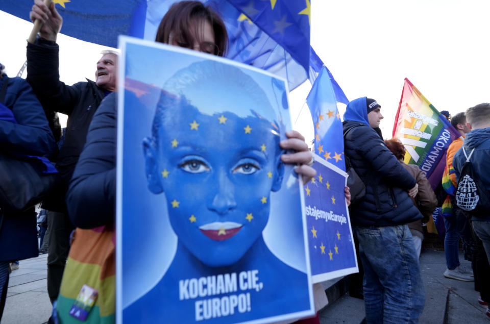 A woman holds a sign in support of Poland's EU membership which reads 'I love you Europe' during a demonstration, in Warsaw, Poland, Sunday, October 10, 2021. Poland's constitutional court ruled Thursday that Polish laws have supremacy over those of the European Union in areas where they clash, a decision likely to embolden the country's right-wing government and worsen its already troubled relationship with the EU. (AP Photo/Czarek Sokolowski)