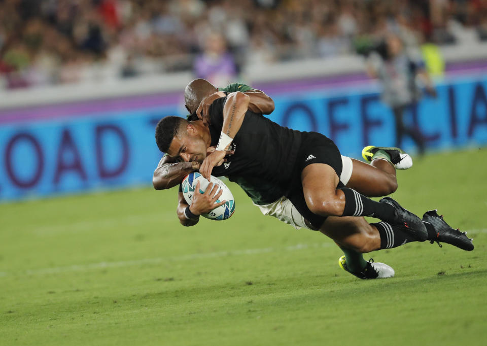 New Zealand's Richie Mo'unga is tackled by South Africa's Makazole Mapimpi during the Rugby World Cup Pool B game between New Zealand and South Africa in Yokohama, Japan, Saturday, Sept. 21, 2019. (AP Photo/Shuji Kajiyama)