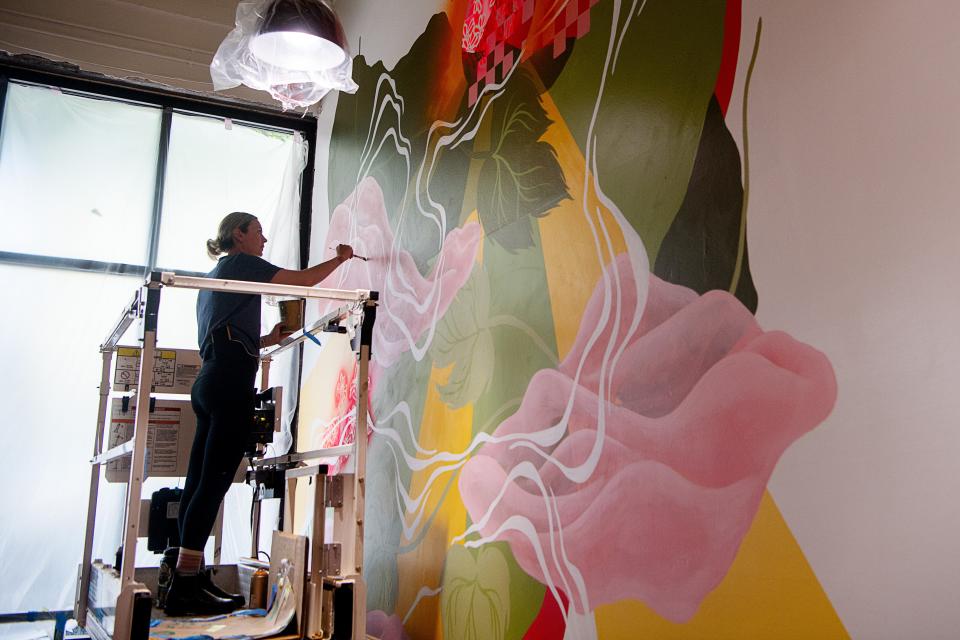 Noelle Miller paints a mural at Vowl, May 6, 2024. On May 17, Vowl, a wine and cocktail bar and event space, will debut at 5 p.m. at 61 North Lexington Ave. downtown, next door to its connected brewery, Dssolvr.
