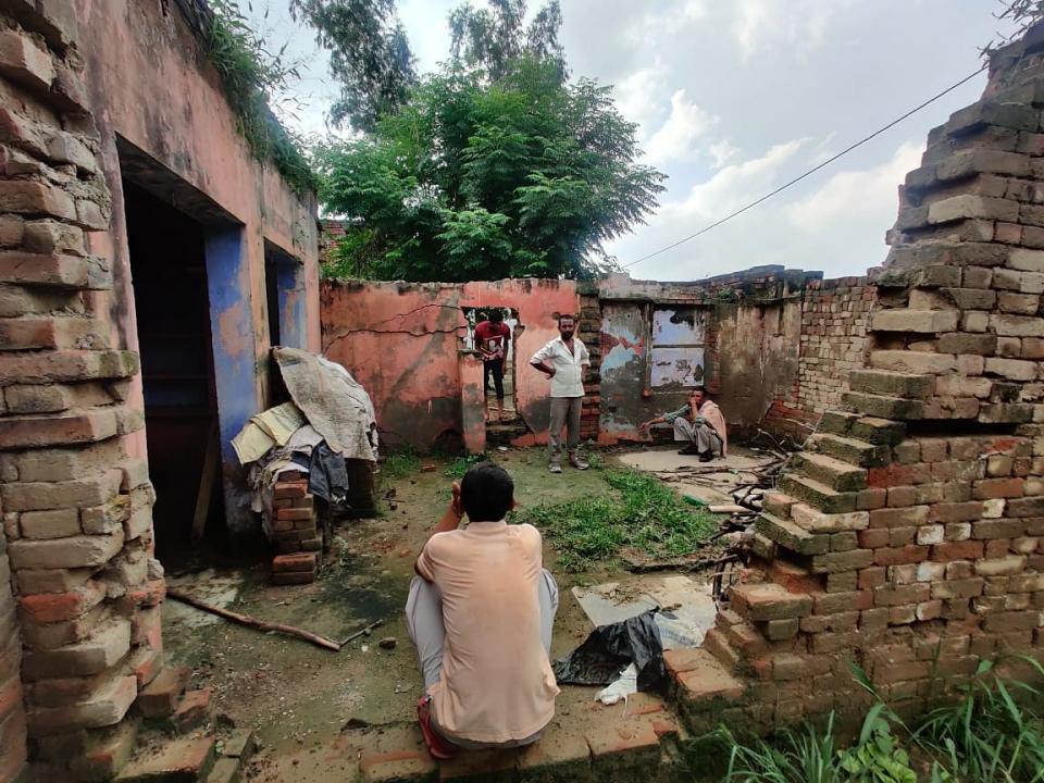 <div class="paragraphs"><p>Standing with his hands on his hips is Sanjeev Kumar. A resident of the village who bought the home Aafreen used to live in.</p></div>