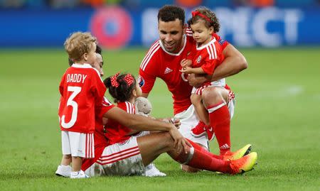 Football Soccer - Wales v Belgium - EURO 2016 - Quarter Final - Stade Pierre-Mauroy, Lille, France - 1/7/16 Wales' Hal Robson-Kanu and Neil Taylor celebrate with children at full time REUTERS/Carl Recine Livepic