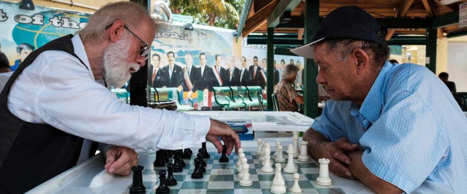 Miami, Florida USA - July 22, 2019: Elderly individuals playing chess in the historic Domino Park in popular Little Havana.