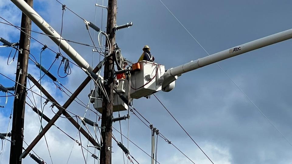 Line workers with Jersey Central Power & Light upgrade transmission lines  crossing Route 18 in Colts Neck.