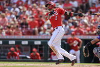 Cincinnati Reds' Nick Castellanos hits an RBI-double during the first inning of a baseball game against the Colorado Rockies in Cincinnati, Saturday, June 12, 2021. (AP Photo/Aaron Doster)