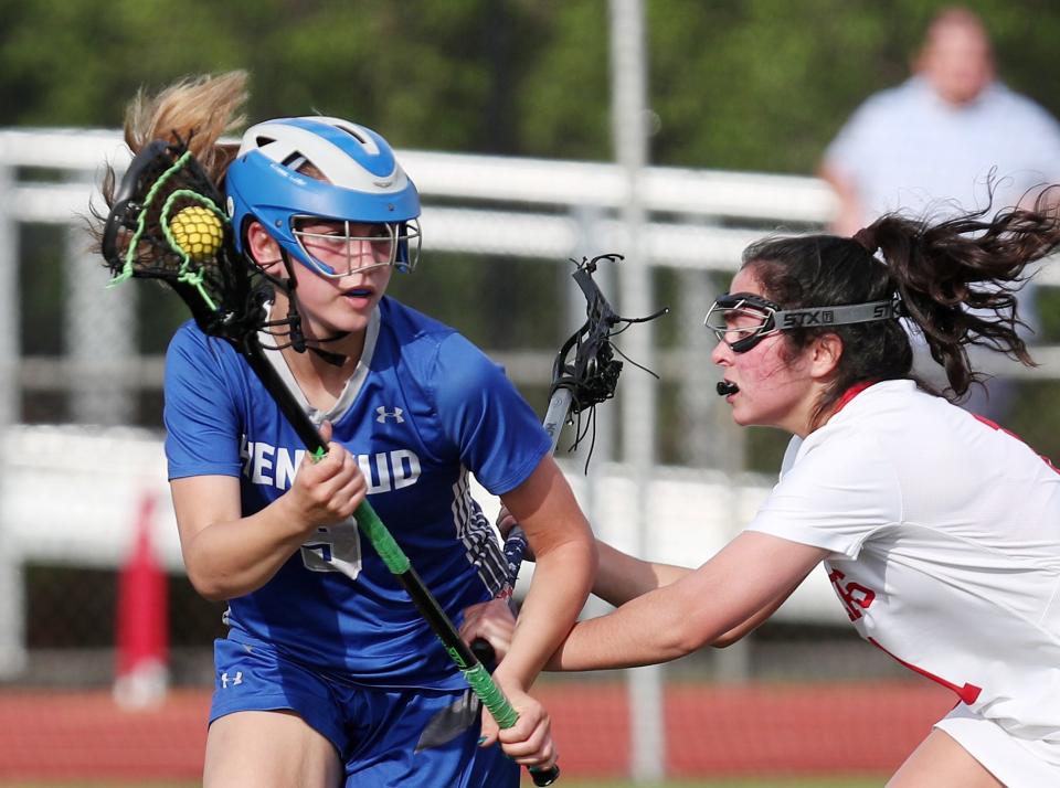Hen Hud's Paige Montgomery (9) tries to get around Somers'  Victoria Olsen (11) during girls lacrosse action at Somers High School May 11, 2023. Somers won the game 12-7.