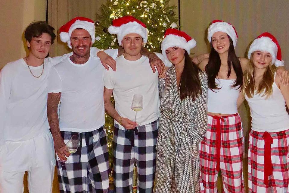 <p>Victoria Beckham/Instagram</p> The Beckham family poses for a Christmas photo.