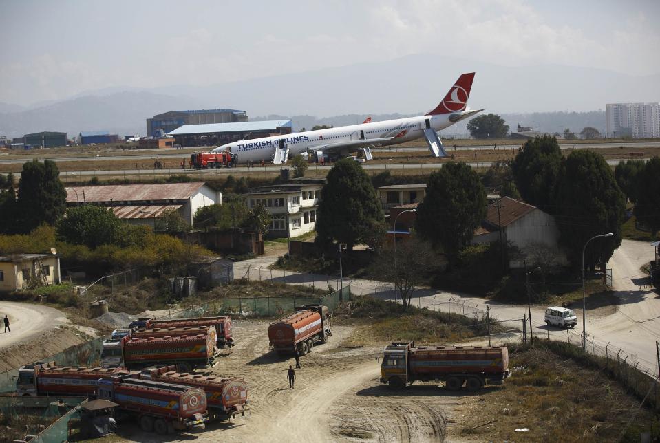 A Turkish Airlines plane lies on the field after it overshot the runway at Tribhuvan International Airport in Kathmandu