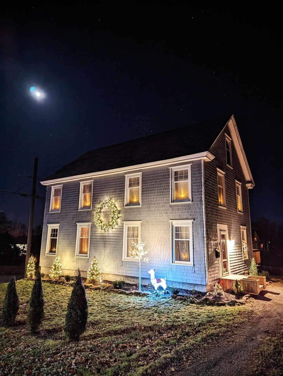 A Nova Scotian home is shown here with plug in candle lights in the windows.