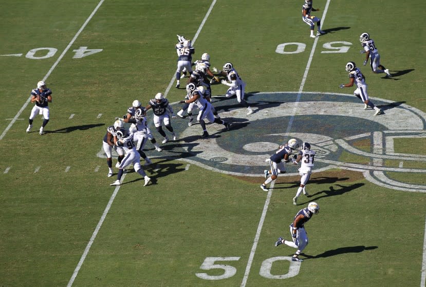 Los Angeles Chargers quarterback Philip Rivers runs a play against the Los Angeles Rams at the Los Angeles Memorial Coliseum on September 23, 2018.