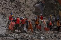 Rescue workers prepare to retrieve the body of a victim at the site of a collapsed tunnel in Ramban district, south of Srinagar, Indian controlled Kashmir, Friday, May 20, 2022. An official in Indian-controlled Kashmir said Friday that 10 workers were trapped after part of a road tunnel collapsed in the Himalayan region. (AP Photo/Dar Yasin)