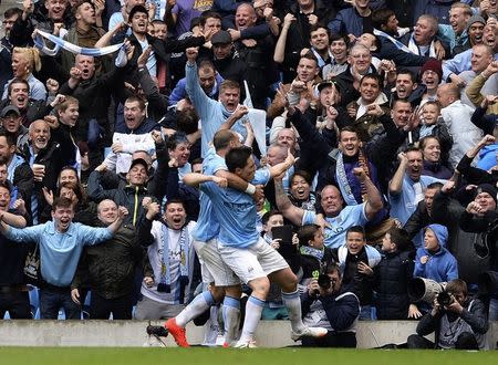 Manchester City's Samir Nasri (R) is congratulated by teammate Pablo Zabaleta after scoring against West Ham United during their English Premier League soccer match at the Etihad Stadium in Manchester, northern England May 11, 2014. REUTERS/Nigel Roddis (BRITAIN - Tags: SPORT SOCCER) FOR EDITORIAL USE ONLY. NOT FOR SALE FOR MARKETING OR ADVERTISING CAMPAIGNS. NO USE WITH UNAUTHORIZED AUDIO, VIDEO, DATA, FIXTURE LISTS, CLUB/LEAGUE LOGOS OR "LIVE" SERVICES. ONLINE IN-MATCH USE LIMITED TO 45 IMAGES, NO VIDEO EMULATION. NO USE IN BETTING, GAMES OR SINGLE CLUB/LEAGUE/PLAYER PUBLICATIONS - RTR3OO23