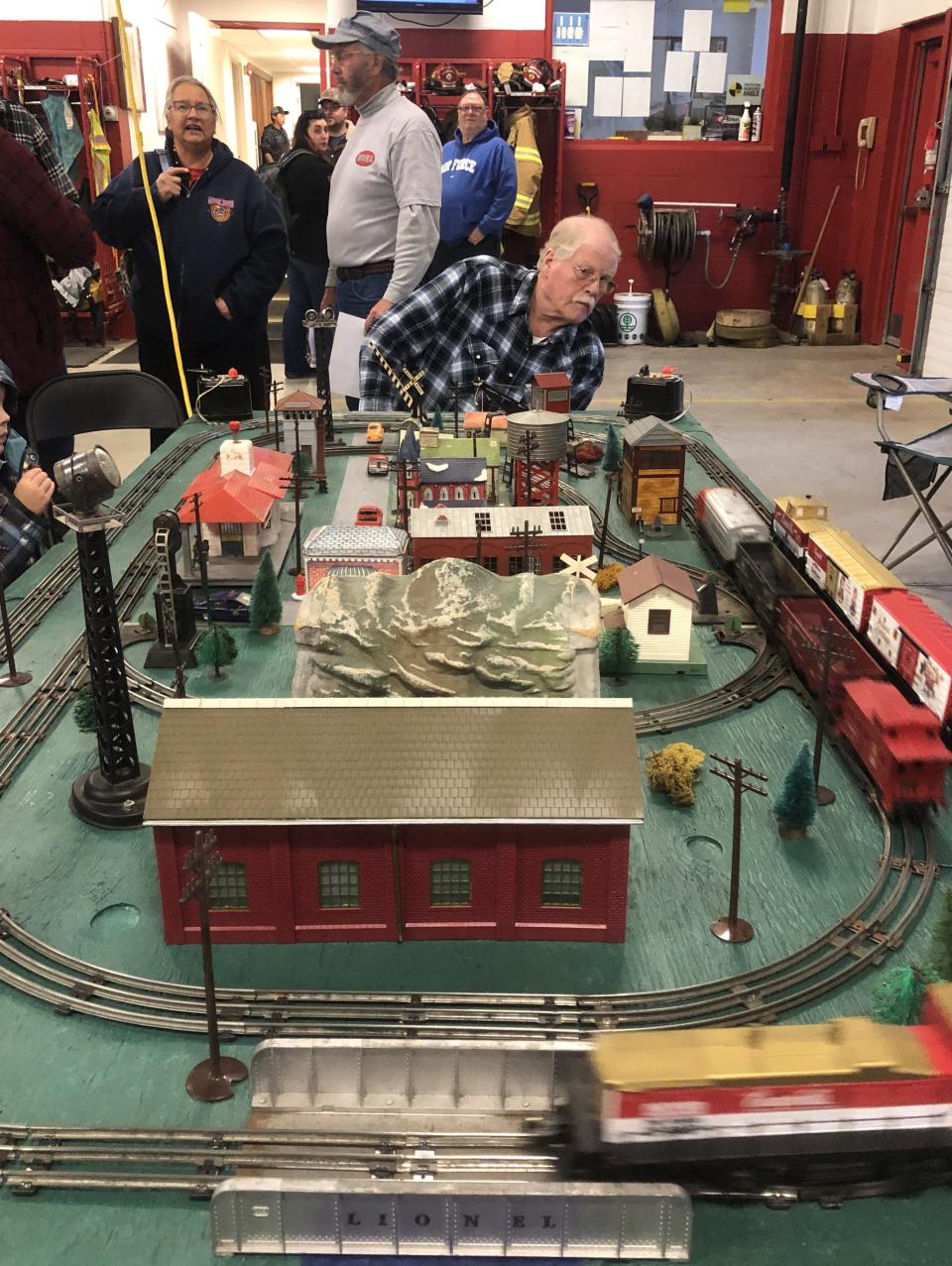 Brad Williams checks on the model train display during the Manchester Fire Department's open house on Saturday.