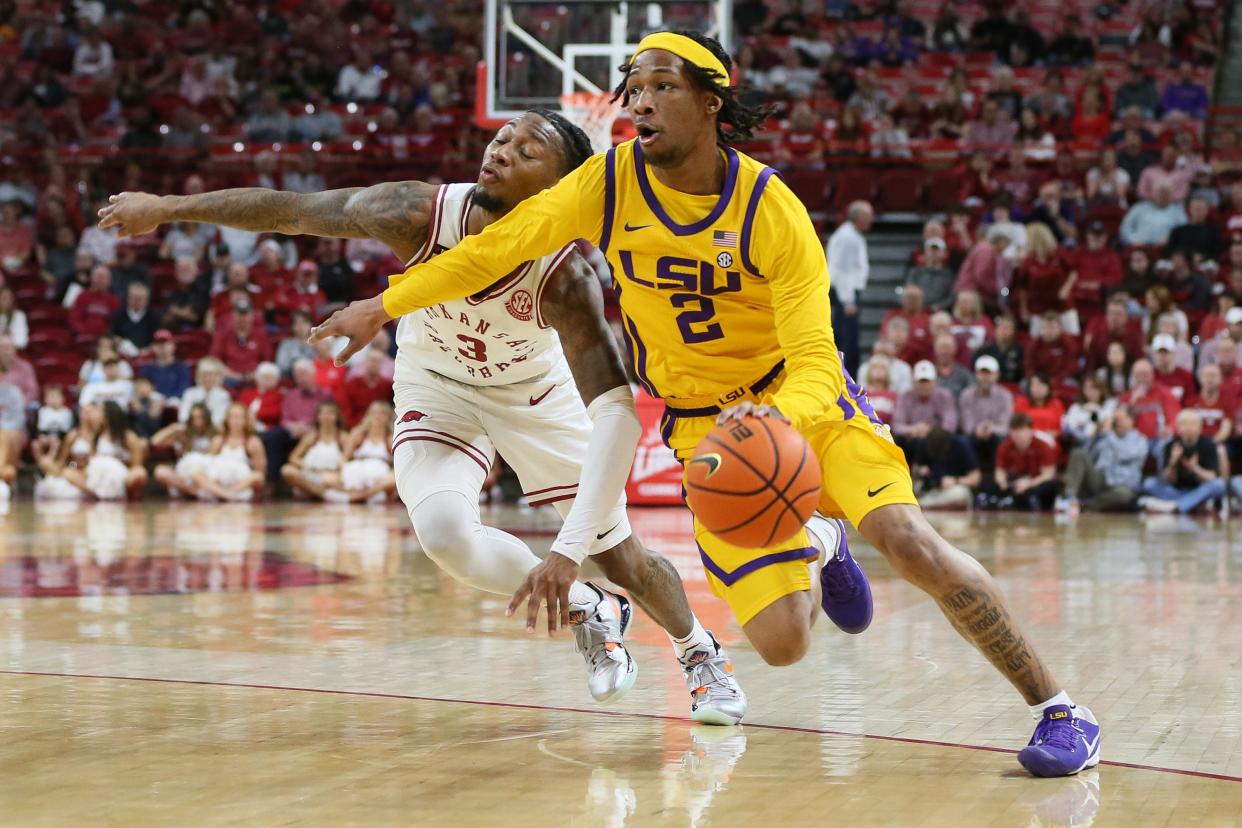 Mar 6, 2024; Fayetteville, Arkansas, USA; LSU Tigers guard Mike Williams III (2) drives against Arkansas Razorbacks guard El Ellis (3) during the first half at Bud Walton Arena. Mandatory Credit: Nelson Chenault-USA TODAY Sports