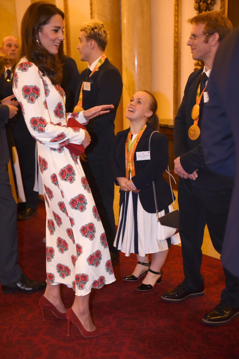 <p>Alexander McQueen proved to be a favourite label for the Duchess again this year with the royal wearing a poppy-printed design to meet members of Team GB. Ever the co-ordinator, Kate chose matching red accessories. <i>[Photo: PA]</i> </p>