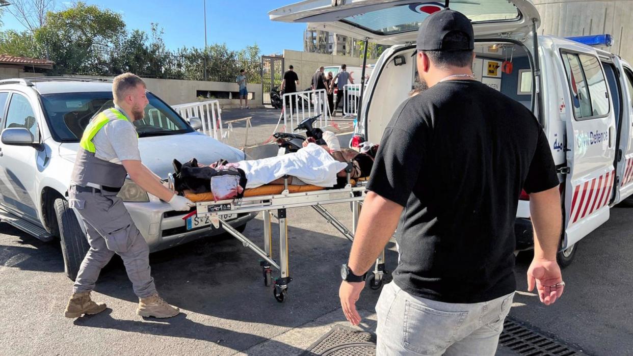 PHOTO: Civil defense first responders carry an injured man whose portable pager exploded at al-Zahraa Hospital in Beirut, Lebanon, Sept. 17, 2024. (Hussein Malla/AP)