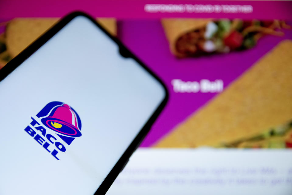 GREECE - 2021/05/07: In this photo illustration a Taco Bell logo seen displayed on a smartphone screen with Taco Bell website in the background. (Photo Illustration by Nikolas Joao Kokovlis/SOPA Images/LightRocket via Getty Images)