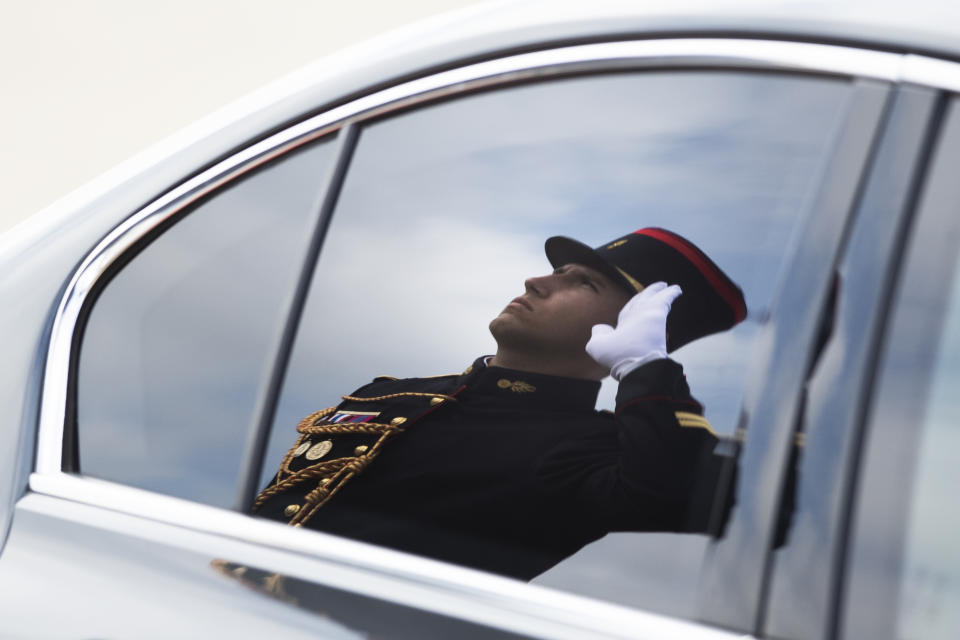 An honor guard is reflected in the window of Italian Prime Minister Giuseppe Conte after his arrival at the airport in Biarritz, France, for the first day of the G-7 summit, Saturday, Aug. 24, 2019. U.S. President Donald Trump and the six other leaders of the Group of Seven nations will begin meeting Saturday for three days in the southwestern French resort town of Biarritz. France holds the 2019 presidency of the G-7, which also includes Britain, Canada, Germany, Italy and Japan. (AP Photo/Peter Dejong)