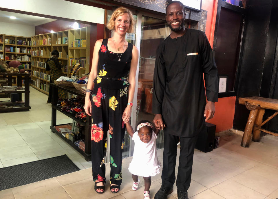 This Nov. 17, 2019 photo provided by the family shows Robin Gallite, left, Adebambo Alli and their adopted daughter, Adenike-Rae, at Terra Kulture a mixed use art space that promotes the richness and diversity of Nigerian languages, arts and culture, in Lagos, Nigeria. Stranded in Nigeria for months, the couple had a rare chance to board a U.S-bound evacuation flight amid the coronavirus outbreak. They refused to fly because Adenike-Rae has yet to receive a U.S. visa and they would have had to leave her behind. (Courtesy Robin Gallite via AP)