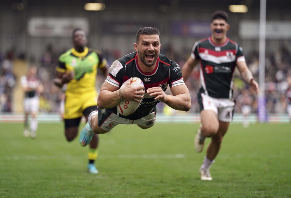 Lebanon's Josh Mansour dives in to score a try during their Rugby League World Cup group C match against Jamaica at the Leigh Sports Village, Leigh, England, Sunday, Oct. 30, 2022. (Tim Goode/PA via AP)