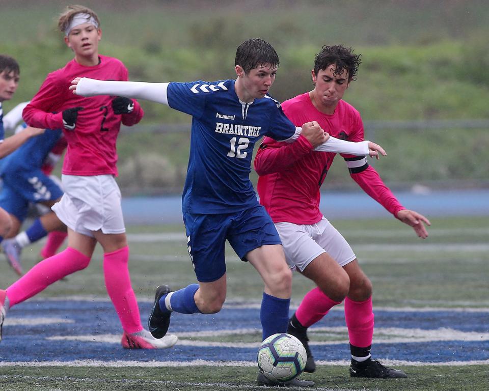 Braintree's Calum McClorey is held by Bridgewater-Raynham's Tyler Moreira during a game at Braintree High on Tuesday, Oct. 4, 2022.