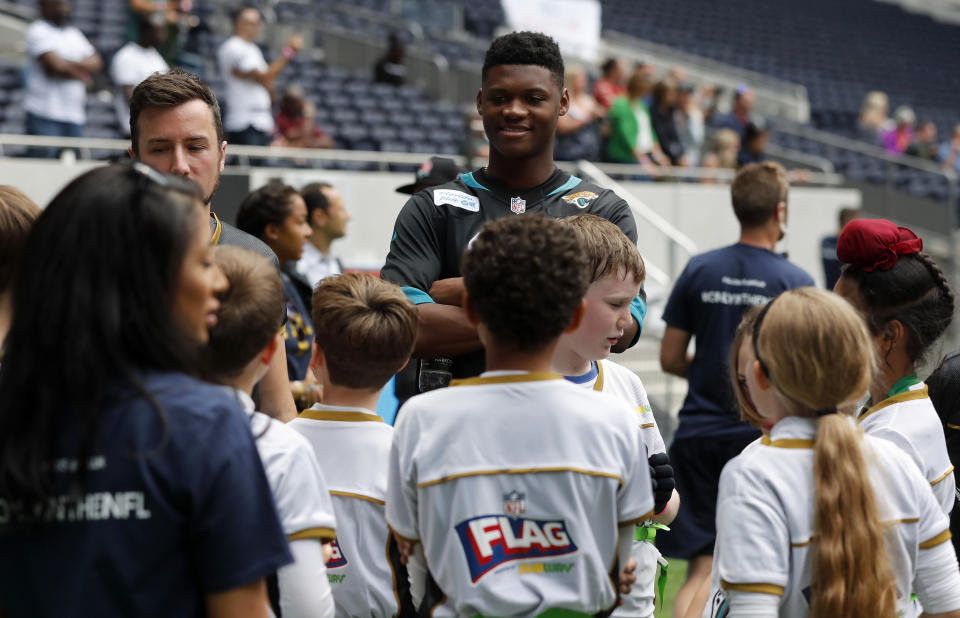 NFL player DJ Chark speaks to young players during the final tournament for the UK's NFL Flag Championship, featuring qualifying teams from around the country, at the Tottenham Hotspur Stadium in London, Wednesday, July 3, 2019. The new stadium will host its first two NFL London Games later this year when the Chicago Bears face the Oakland Raiders and the Carolina Panthers take on the Tampa Bay Buccaneers. (AP Photo/Frank Augstein)