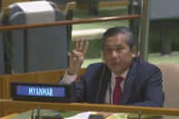 In this image taken from video by UNTV, Myanmar Ambassador to the United Nations Kyaw Moe Tun flashes the three-fingered salute, a gesture of defiance done by anti-coup protesters in Myanmar, at the end of his speech before the U.N. General Assembly at the United Nations Friday, Feb. 27 , 2021. Myanmar’s U.N. ambassador strongly opposed the military coup in his country and appealed for the “strongest possible action from the international community” to immediately restore democracy in a dramatic speech to the U.N. General Assembly Friday that drew loud applause from many diplomats in the 193-nation global body. (UNTV via AP)
