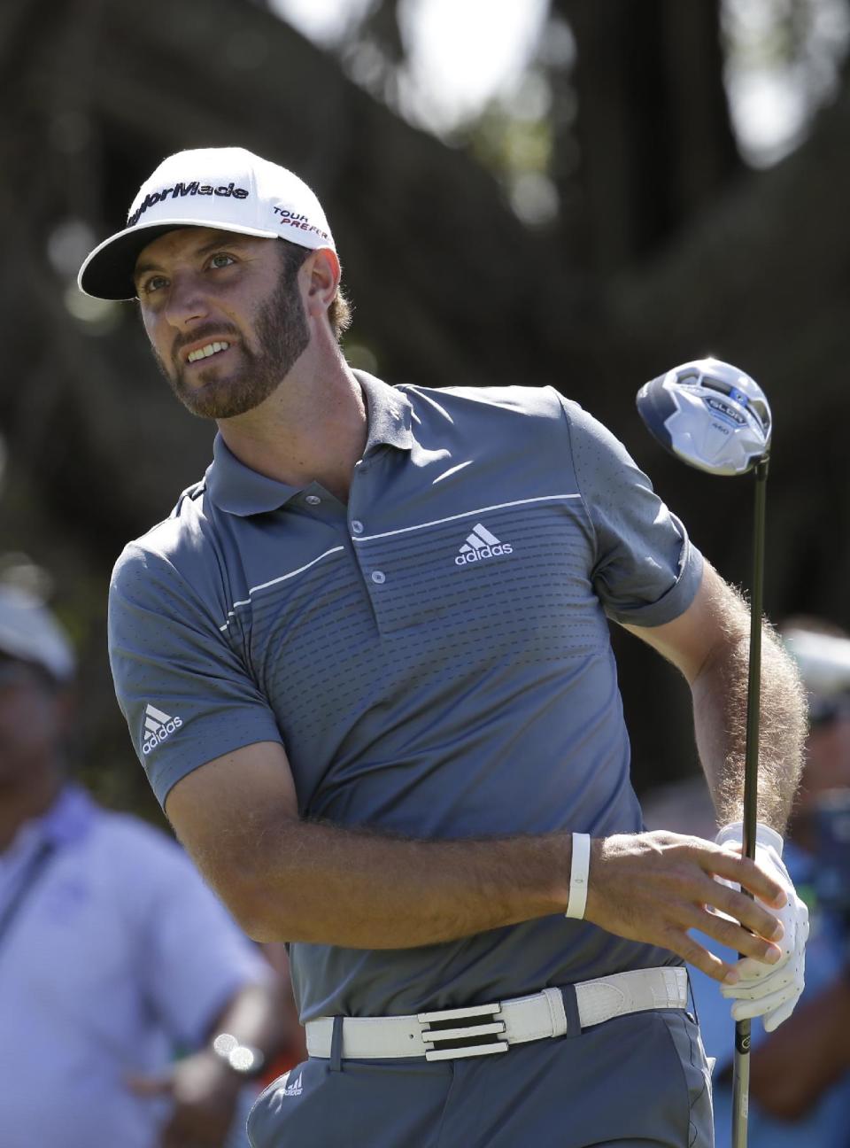 Dustin Johnson watched his shot from the fifth tee during the second round of the Cadillac Championship golf tournament Friday, March 7, 2014, in Doral, Fla. (AP Photo/Lynne Sladky)