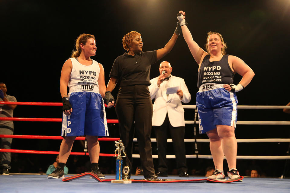 <p>Katie Walsh’s arm is raised in the air by referee as the winner of the Female Grudge Match over Stacy Weinstein at the NYPD Boxing Championships at The Theater at Madison Square Garden on June 8, 2017. (Photo: Gordon Donovan/Yahoo News) </p>