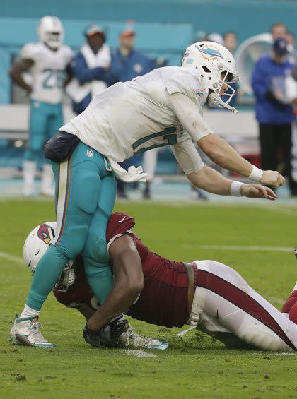 Knees don't bend like that: Calais Campbell went low on Ryan Tannehill. (AP)