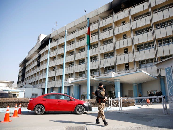 An Afghan security force walks in front of the Intercontinental Hotel after an attack in Kabul, Afghanistan January 23, 2018.REUTERS/Mohammad Ismail