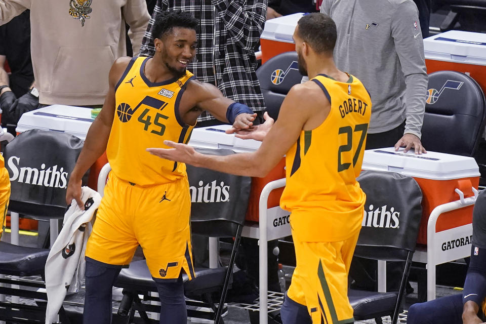 Utah Jazz's Donovan Mitchell (45) celebrates with Rudy Gobert (27) after leaving the game during the second half of the team's NBA basketball game against the New Orleans Pelicans on Tuesday, Jan. 19, 2021, in Salt Lake City. (AP Photo/Rick Bowmer)