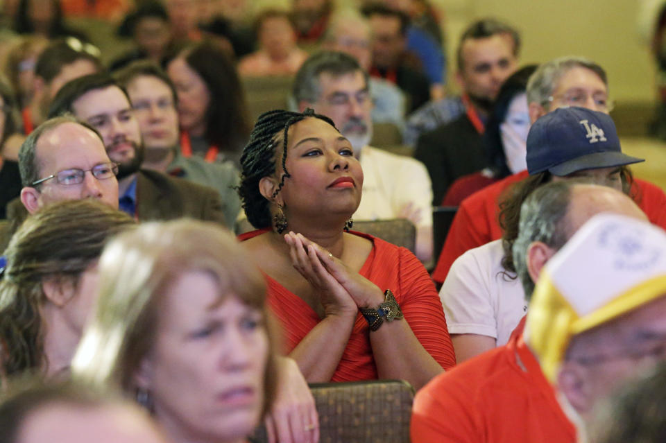 People look on as David Silverman, president of the American Atheists, addresses the American Atheists National Convention in Salt Lake City on Friday, April 18, 2014. In an effort to raise awareness and attract new members, the organization is holding their national conference over Easter weekend in the home of The Church of Jesus Christ of Latter-day Saints. (AP Photo/Rick Bowmer)