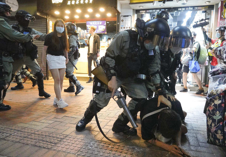 Hong Kong Riot police detain a protester during a protest in Causeway Bay, Hong Kong, Friday, June 12, 2020. Protesters in Hong Kong got its government to withdraw extradition legislation last year, but now they're getting a more dreaded national security law, and the message from Beijing is that protest is futile.(AP Photo/Vincent Yu)