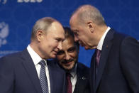 FILE - In this Jan. 8, 2020 file photo, Turkey's President Recep Tayyip Erdogan, right and Russia's President Vladimir Putin, left, talk during a ceremony in Istanbul for the inauguration of the TurkStream pipeline. A summit meeting between the Turkish and Russian leaders scheduled for Thursday, March 5, 2020, may be the last chance to work out a deal that avoids a calamity in Syria's northwest. Faced with mounting losses for his troops in Syria and a potential wave of refugees fleeing fighting in northwestern Syria, Turkish President Recep Tayyip Erdogan is eager for a cease-fire and Vladimir Putin is ready to bargain. (AP Photo/Lefteris Pitarakis, File)