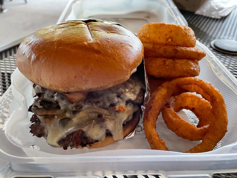Creekside is a venue in the Karns area that hosts a rotating variety of food trucks. Pictured here is the M.O.B burger from Back Alley: Beef and brisket with white cheddar cheese, bacon, white truffle mayo and sautéed mushrooms and onions, with a side of onion rings.