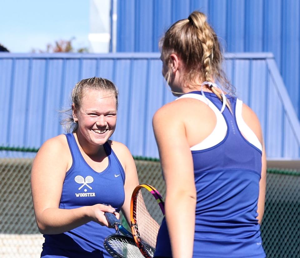 Wooster's Grace Grey (left) and Deah Bresson share a laugh during their first-round battle in sectional play.