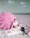 <p>Rock Hudson and Vera-Ellen enjoy the dog days of summer while lounging on a beach towel, circa 1955.</p>