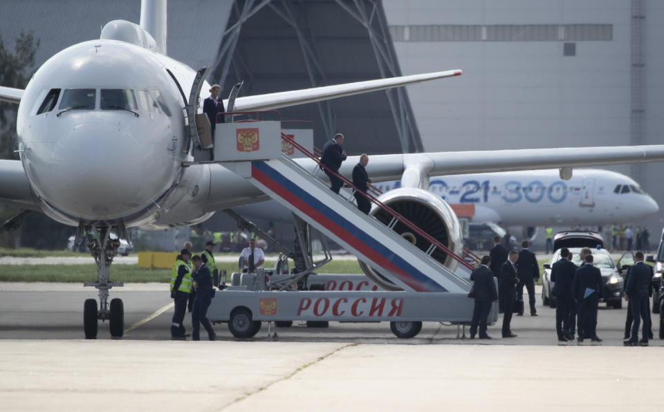 Russian President Vladimir Putin, centre, walks down the stairs from his plane as he arrives to attend the MAKS-2019 International Aviation and Space Show in Zhukovsky, outside Moscow, Russia, Tuesday, Aug. 27, 2019. (AP Photo/Pavel Golovkin)