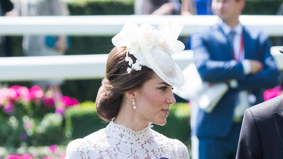 Kate in white dress featuring a lacy neckline and sleeves