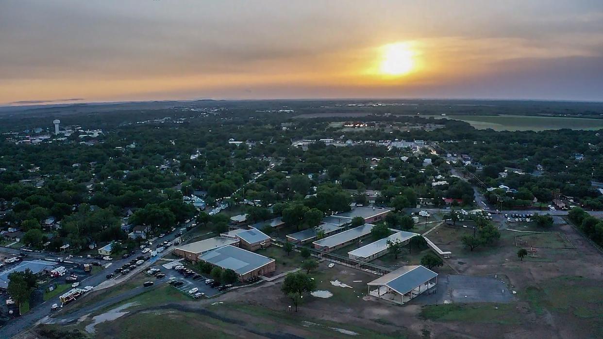 The sun rises over Robb Elementary School on the morning of May 25, 2022 after a gunman killed 19 children and two adults in the town of Uvalde, Texas.