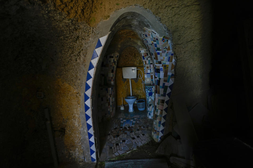 Mosaic decorated toilets sit in a stone-cut chamber in Nissim Kahlon's home chiseled out of the sandstone cliffs overlooking the Mediterranean sea in Herzliya, Israel, Wednesday, June 28, 2023. Over half a century, Kahlon has transformed a tiny cave on a Mediterranean beach into an elaborate underground labyrinth filled with chiseled tunnels, detailed mosaic floors and a network of staircases and mysterious chambers. Fifty years after Kahlon moved into the home, Israel's Environmental Protection Agency has served him an eviction notice, claiming the structure threatens Israel's coastline. (AP Photo/Ariel Schalit)